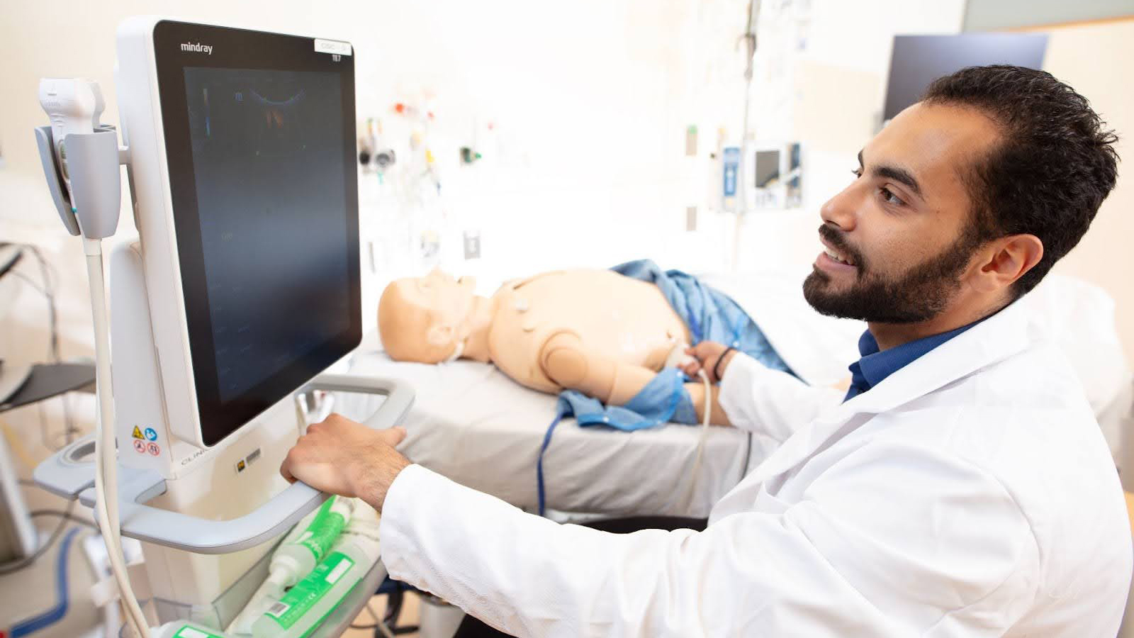  A man performing a medical procedure on a manikin.