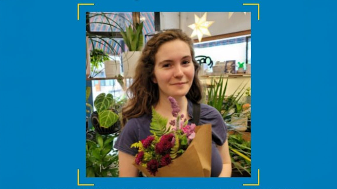 A photo of Angela Voit holding a bouquet of flowers