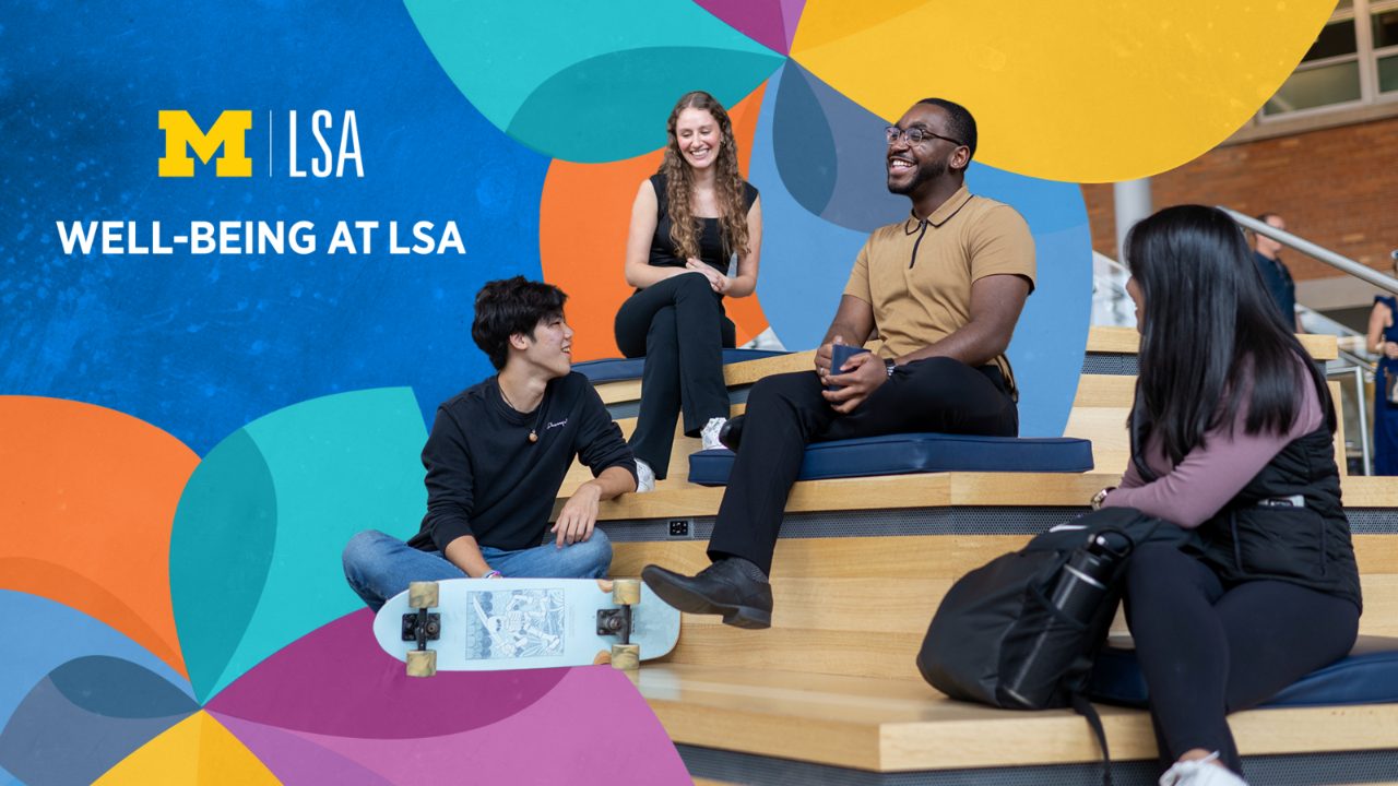 Four students sit together on wooden steps beneath colorful graphics promoting well-being at LSA.