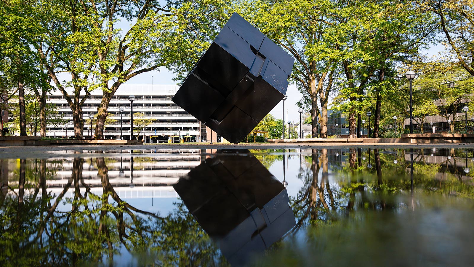 The Cube, surrounded by a large puddle after rain.