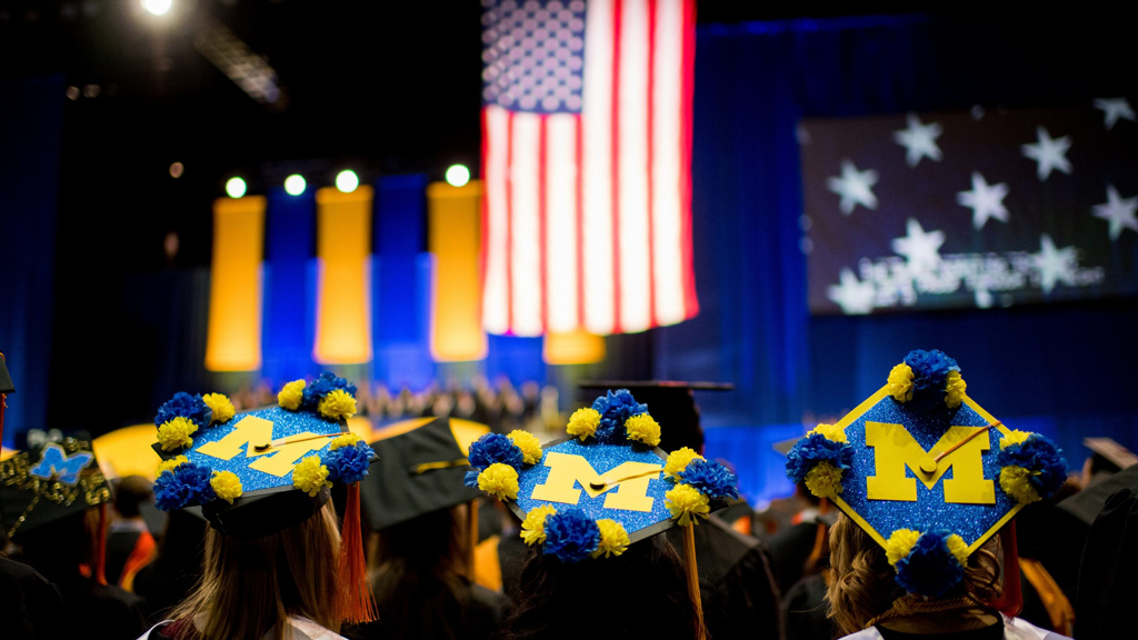 Students with decorated graduation caps at 2019's commencement.