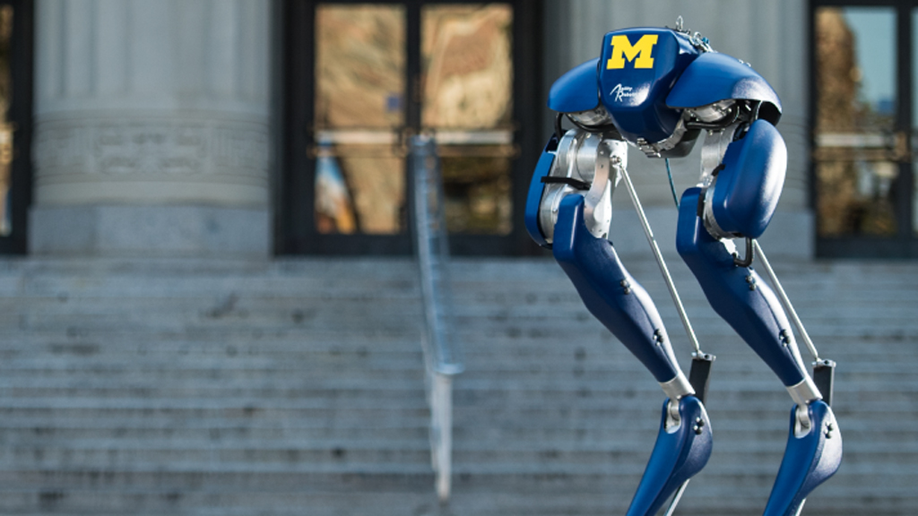 Cassie the robot standing outside of Angell Hall.