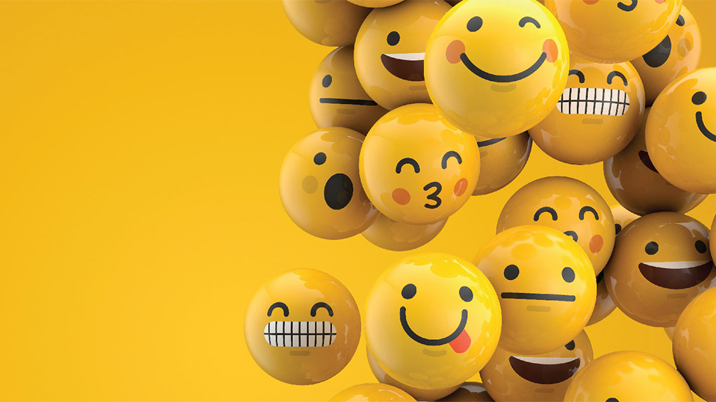 Various emoji facial expression icons in front of a golden yellow background.