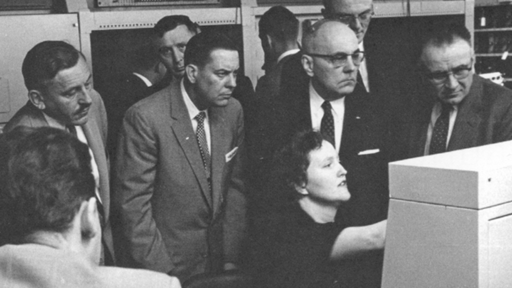 Irma Wyman introduces members of the U.S. Treasury Savings Bond Division to the Datamatic 1000, a first-generation computer.