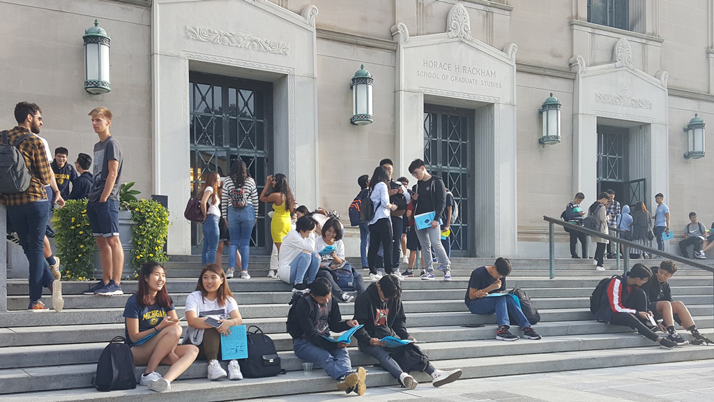 Students gather on the staircase in front of Rackham.