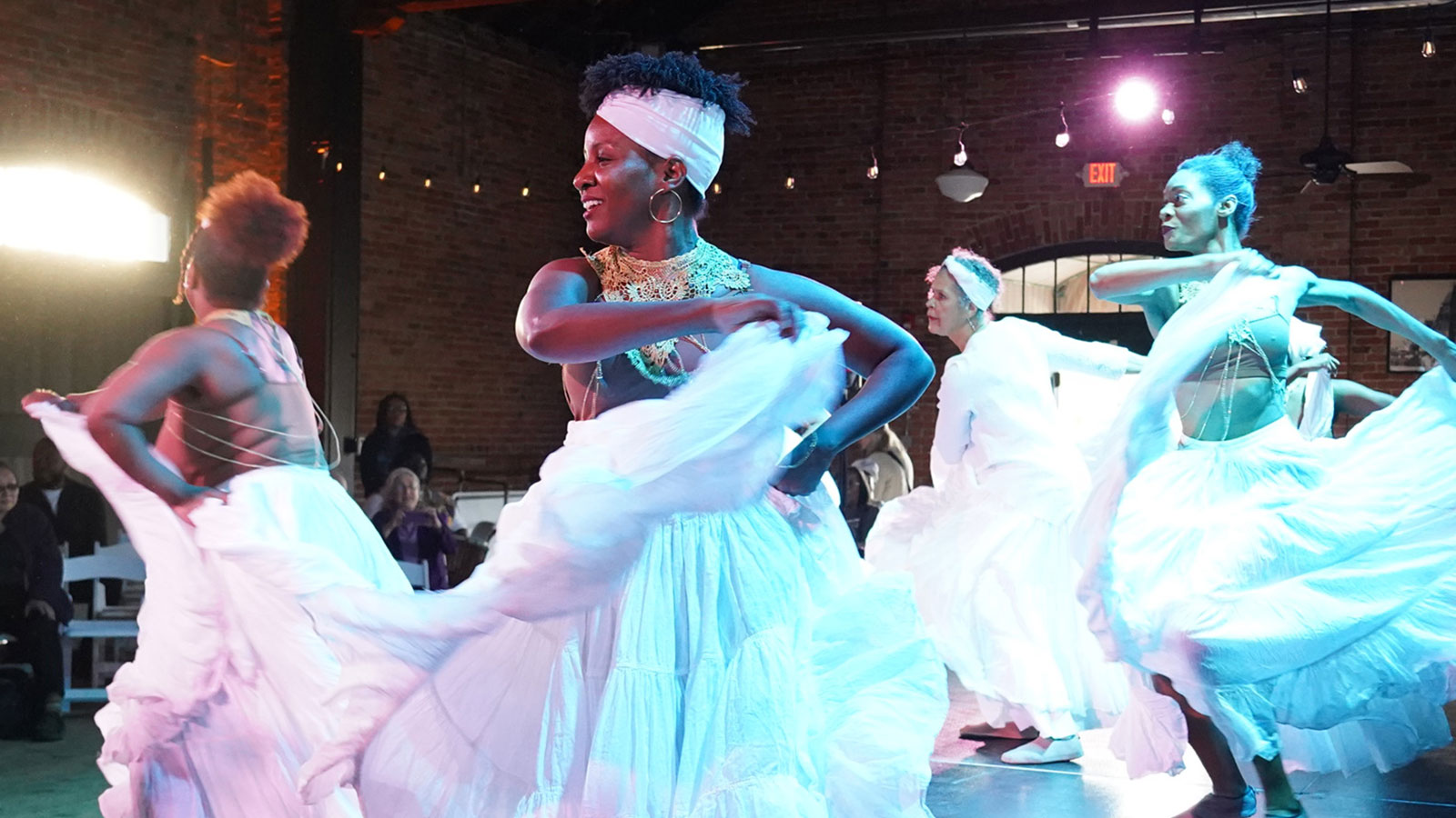 Dancers in swirling white dresses