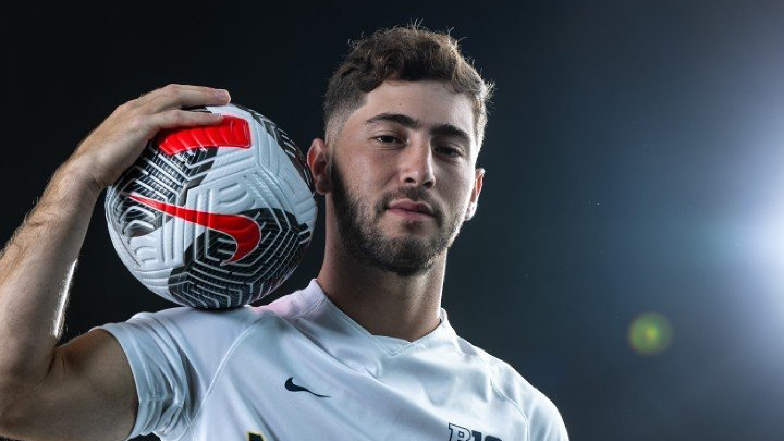 Uriel Zeitz holding a soccer ball on his shoulder