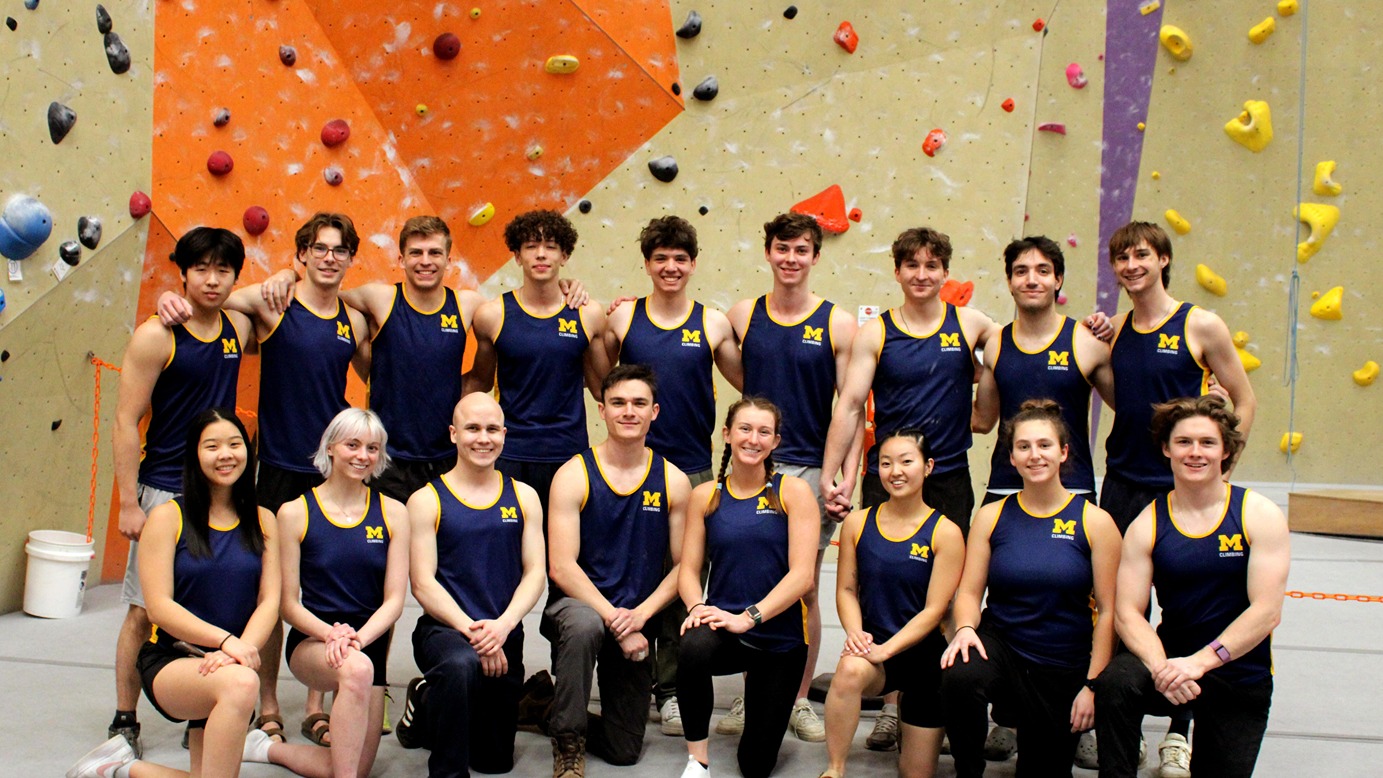 U-M climbing team in front of a rock wall