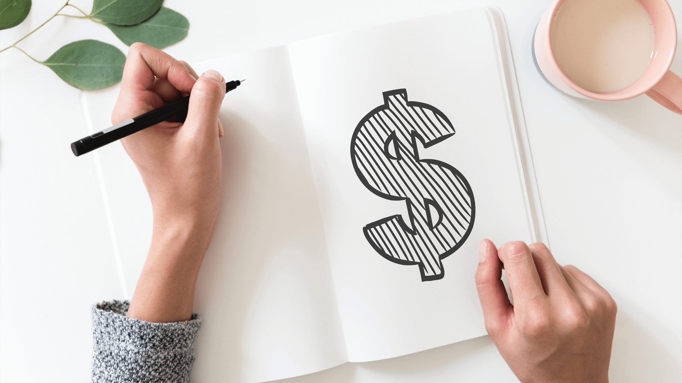 Woman drawing a dollar sign on paper