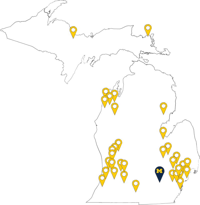 Outline of the state of Michigan with yellow map markers on the 30 cities that have participated in the Aspirnaut Program