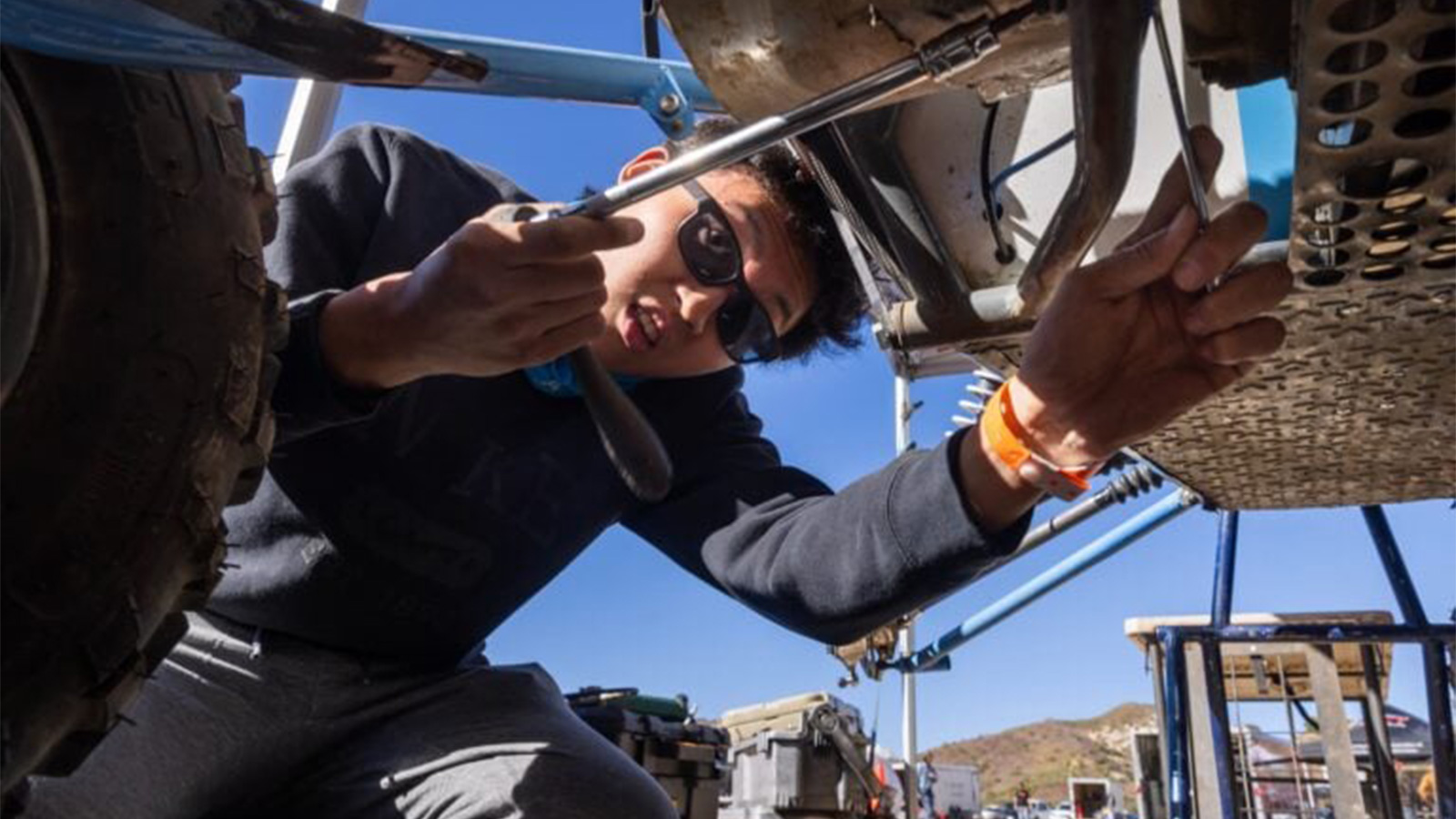 U‑M Baja team member Hyun Jun Ha, responsible for CVT, works on the car to get it ready for the tough Suspension Durability section of the California competition.