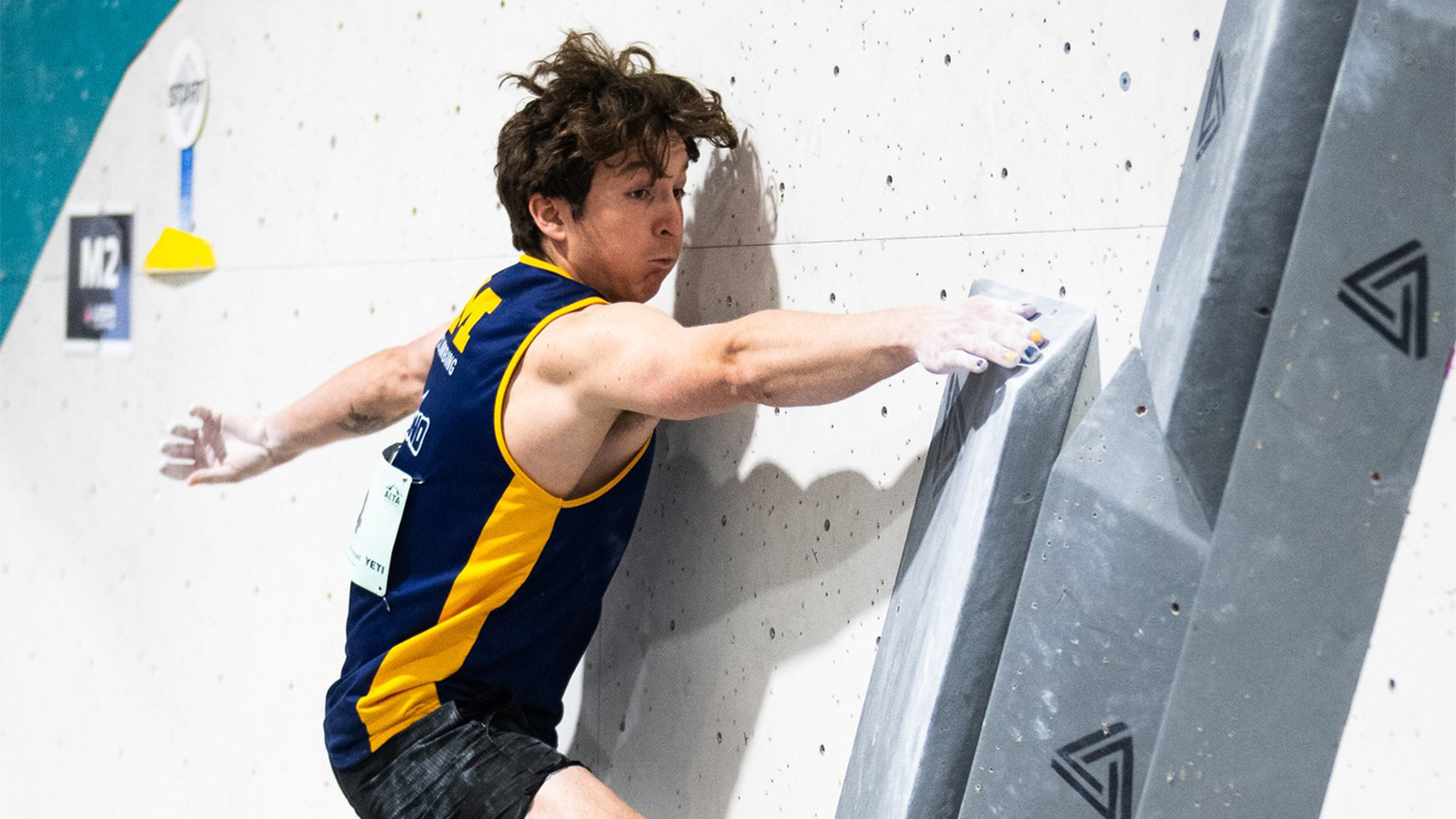 A U‑M climber on a rock wall.