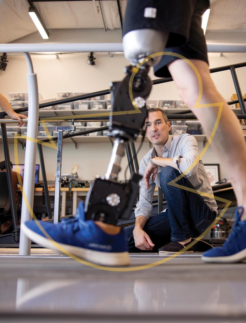 The lower half of a person walking with a prosthetic leg, and a man kneeling down behind them to observe.