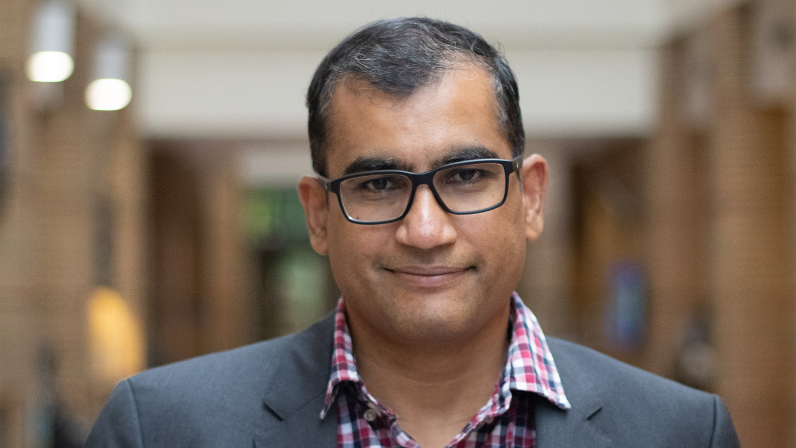 Karthik Duraisamy standing in a hallway.