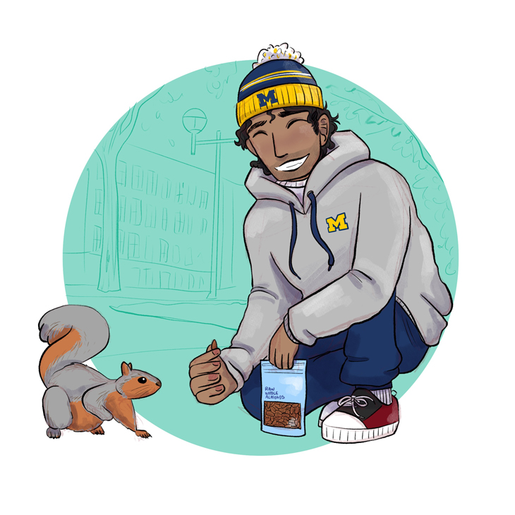 A male student feeds a squirrel almonds.
