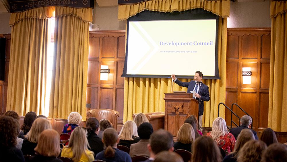 Santa Ono at a podium giving a speech to development colleagues.