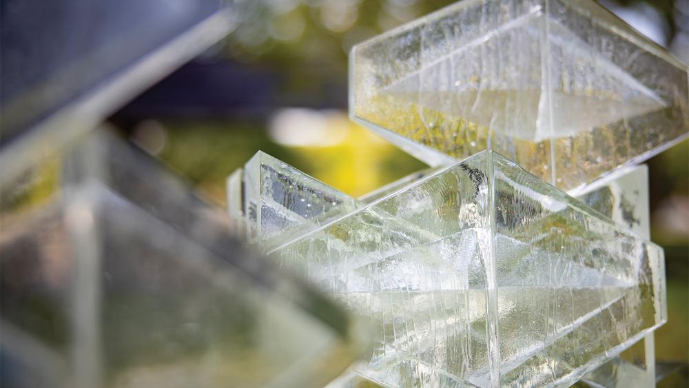 A close-up portrait of the glass that will be used to design the outdoor alcove at Campus Farm.