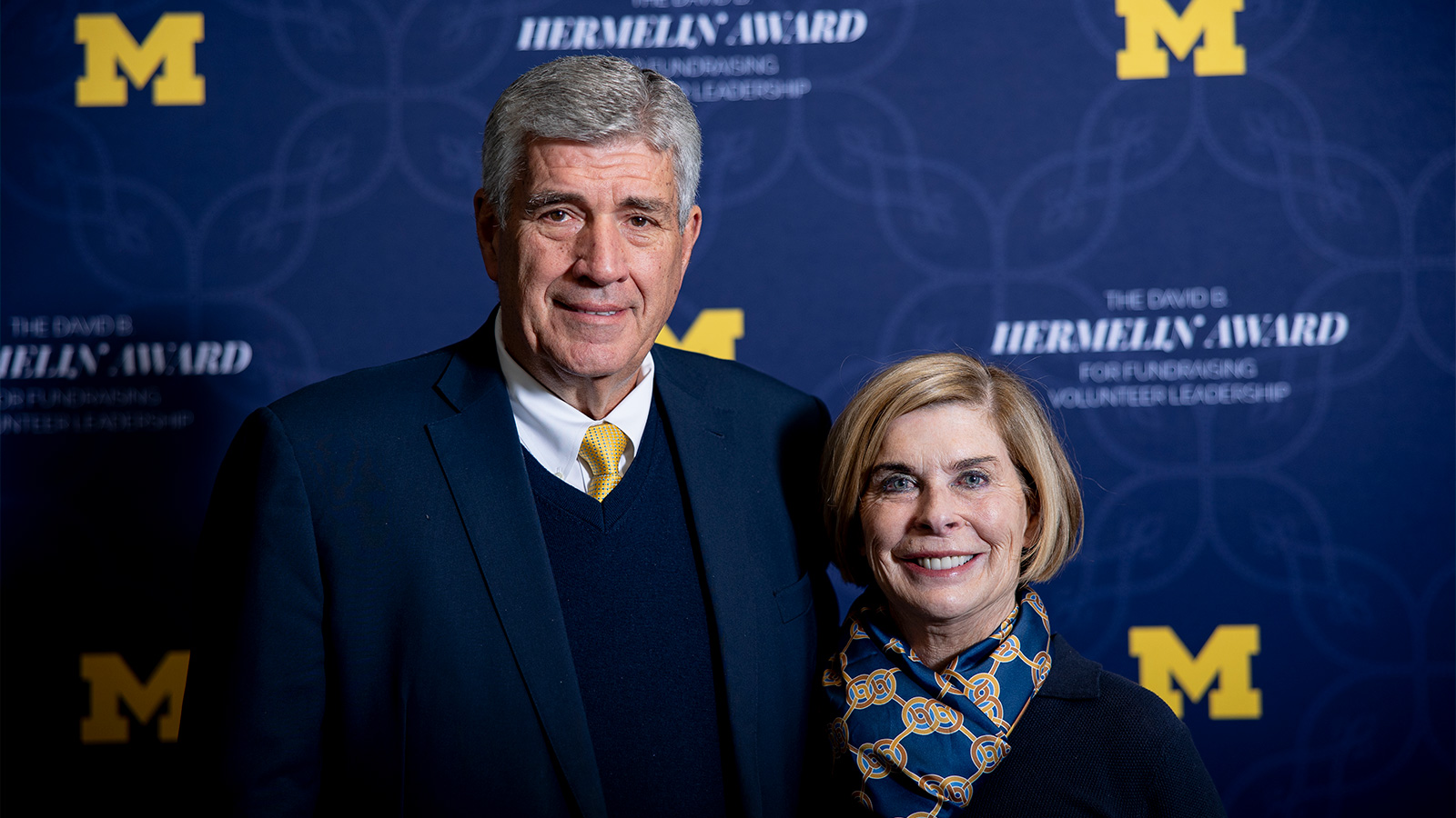 Kathleen and Bryan Marsal in front of a Hermelin Awards backdrop.