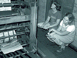 Ann Marie Lipinski watching newspapers being printed at Michigan Daily in 1977.