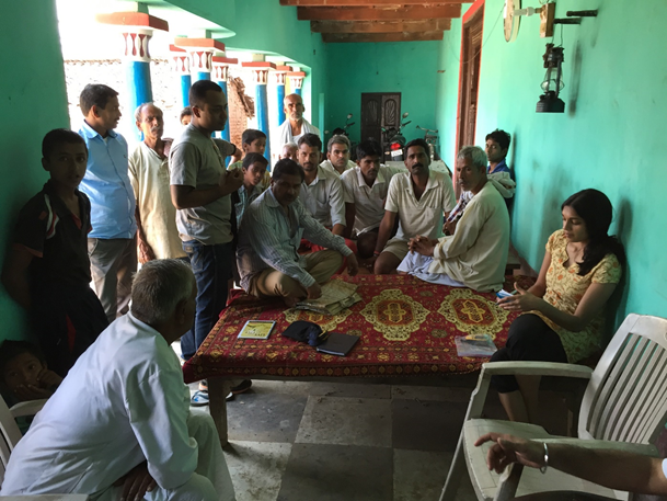 Discussion around a table in India.