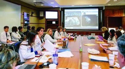 Medical professionals sitting around a table.