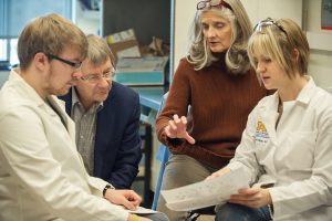 Four people having a discussion in the U‑M Depression Center.