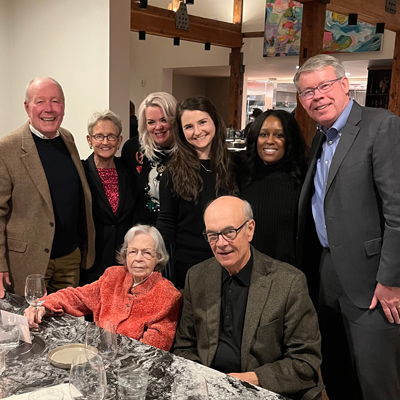 Molly sitting with family and friends from U‑M.