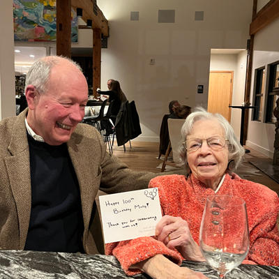 Molly holding up a birthday card and smiling.