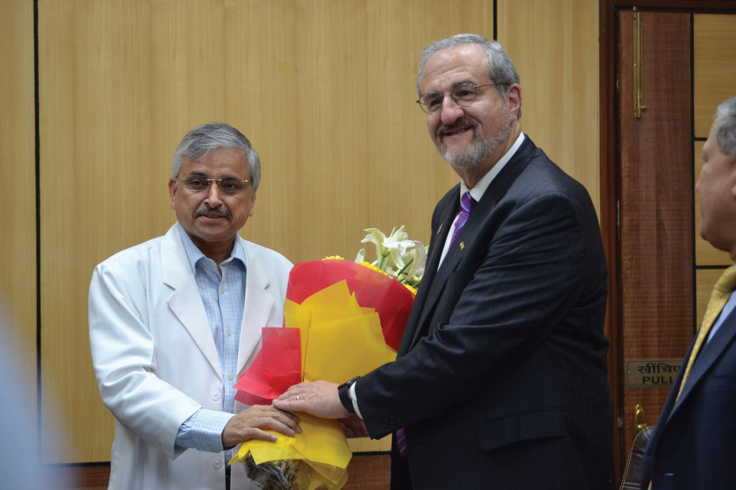 Randeep Guleria shakes hands with President Schlissel.