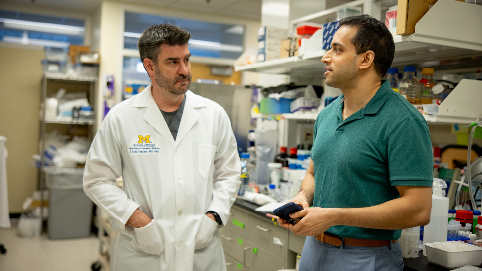 J. Scott VanEpps and Vishu Asthana standing in the lab, having a conversation. 