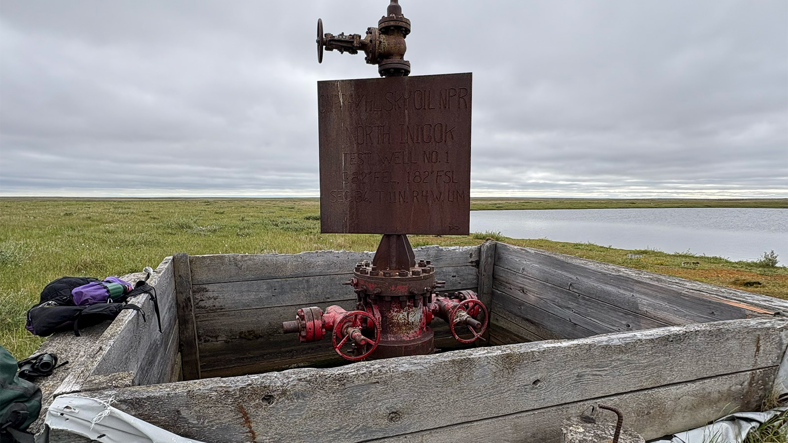 An oil well standing in the Arctic landscape.