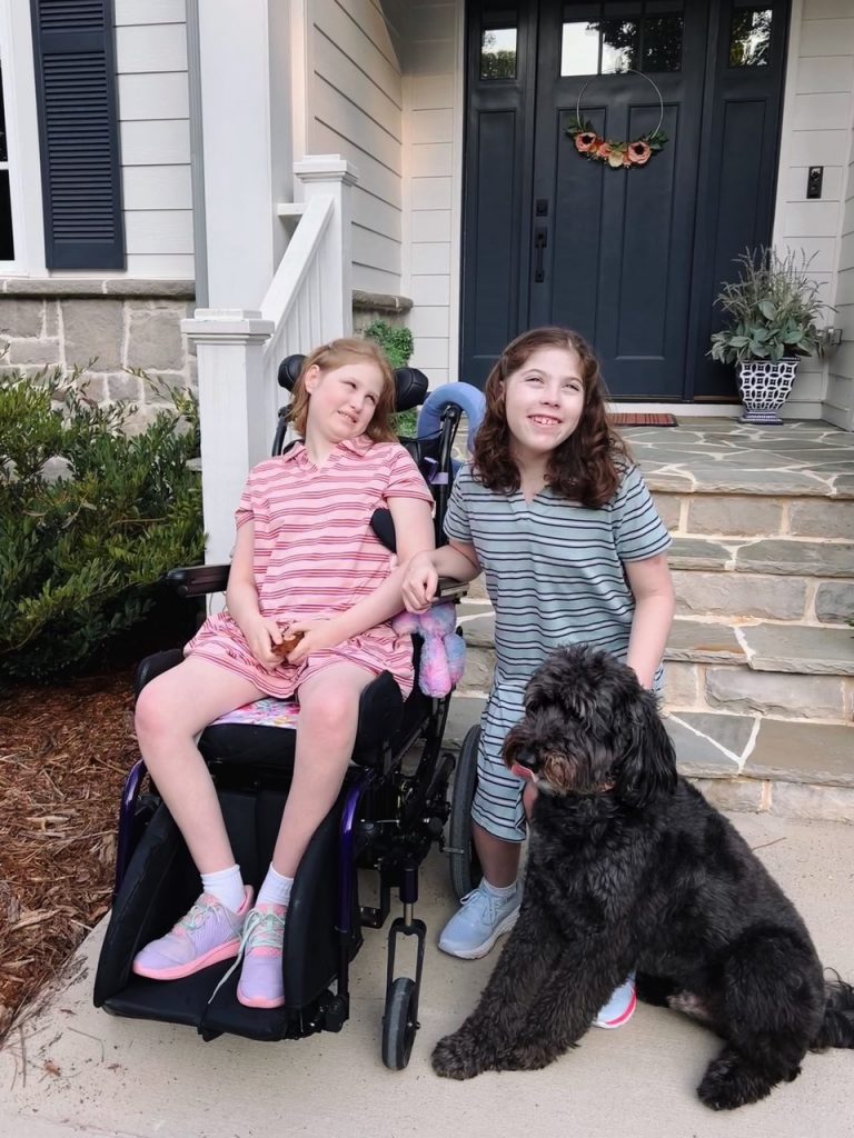 Amelia and Makenzie Kahn with their dog Pongo