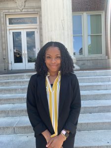 Kori Maxie in front of campus building.