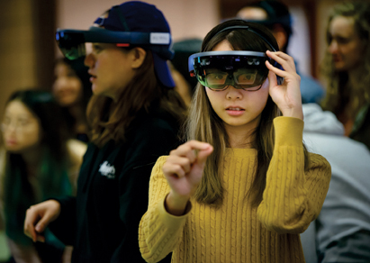 Students wearing augmented reality headsets.