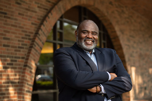 Robert Sellers standing in front of the administration building.