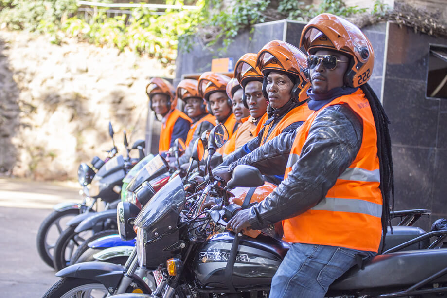 SafeBoda drivers posing on their motorcycles.