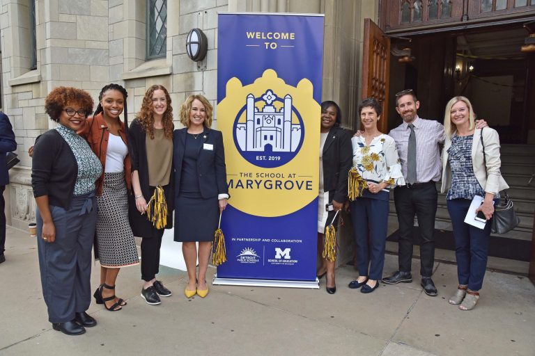 Marygrove students and staff members standing in front of the school's entrance.