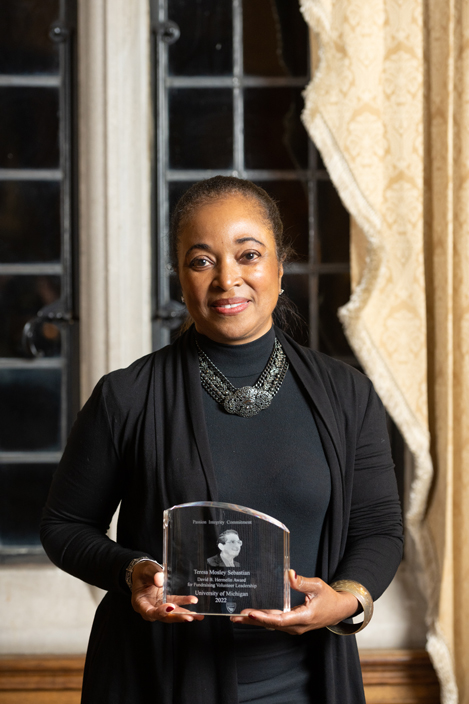 Teresa Sebastian holding her Hermelin Award.