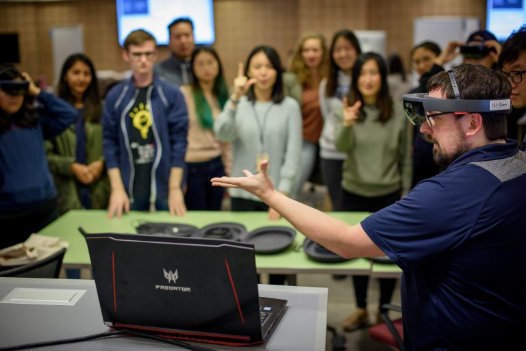A group of U‑M students trying out VR headset during class.