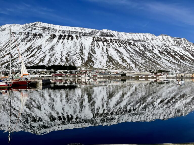 A mountain near a body of water in Iceland.