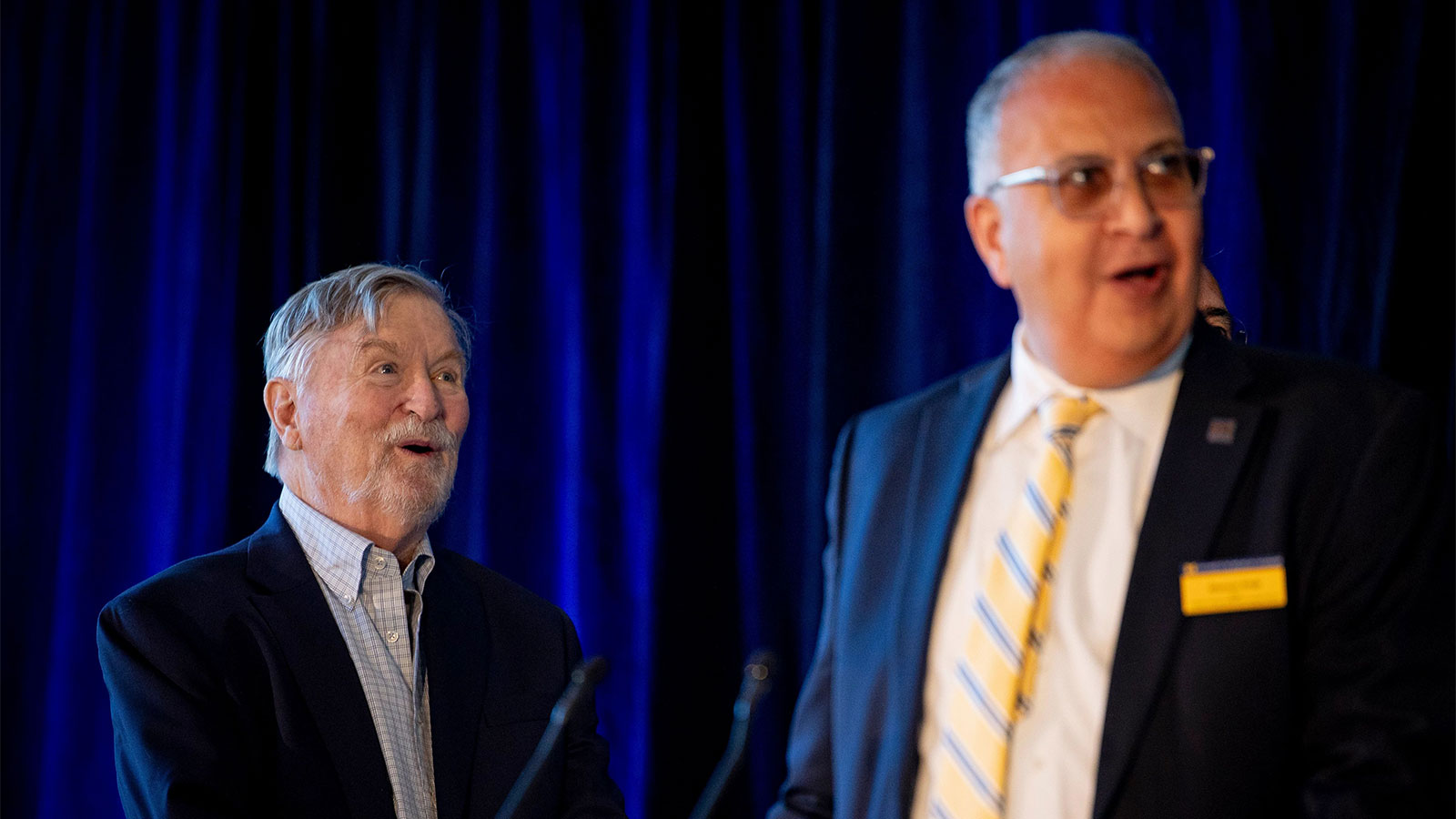 Two men with excited expressions on their faces.