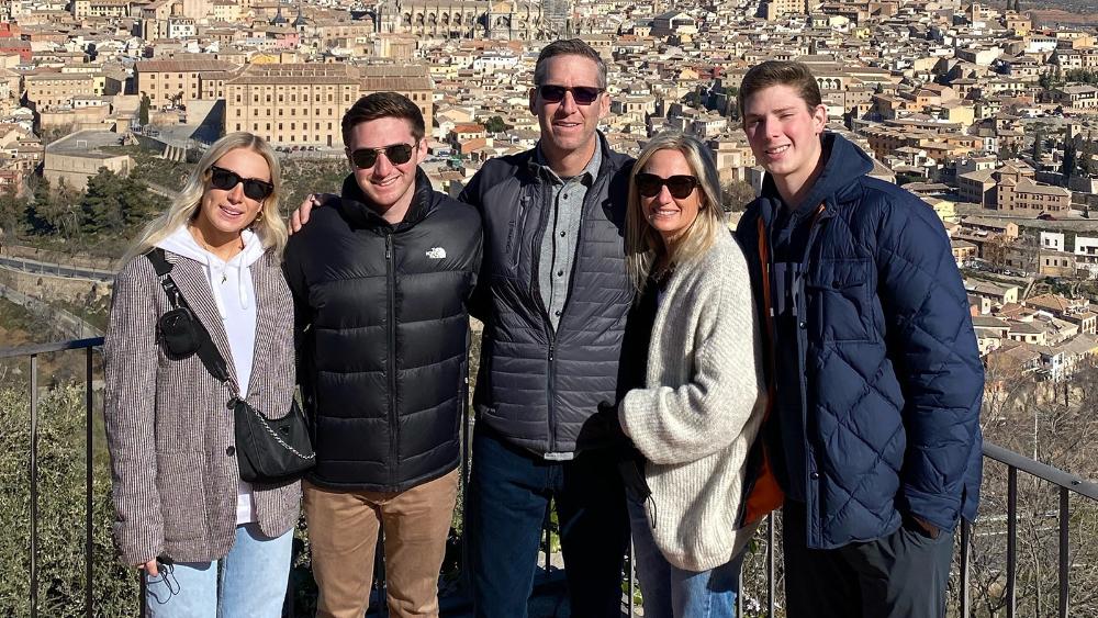 The Rosenthal family standing on a balcony overlook.