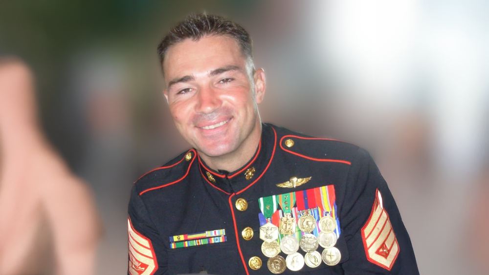 A smiling man in a marine uniform