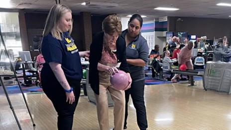 Occupational Therapy students assist a patient in the program’s new disability bowling initiative.  