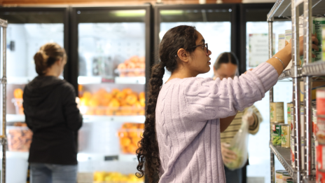 Student volunteers stocking pantry shelves