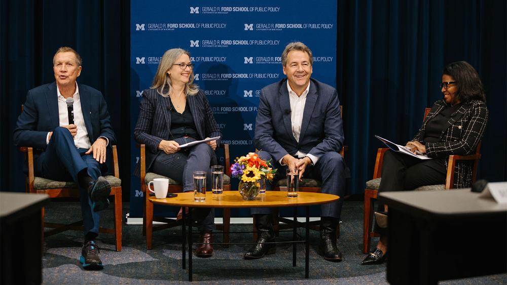 Four speakers in an auditorium having a discussion. From left to right - Governor John Kasich, Professor Jenna Bednar, Governor Steve Bullock, Ford School Dean Celeste Watkins-Hayes 