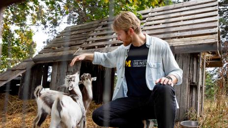 Erb student Gol-Dann Slater petting goats at the Phillips Orchards & Cider Mill.