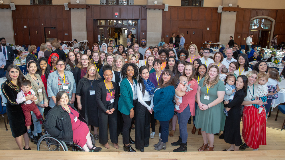 A large group of people smiling at the camera