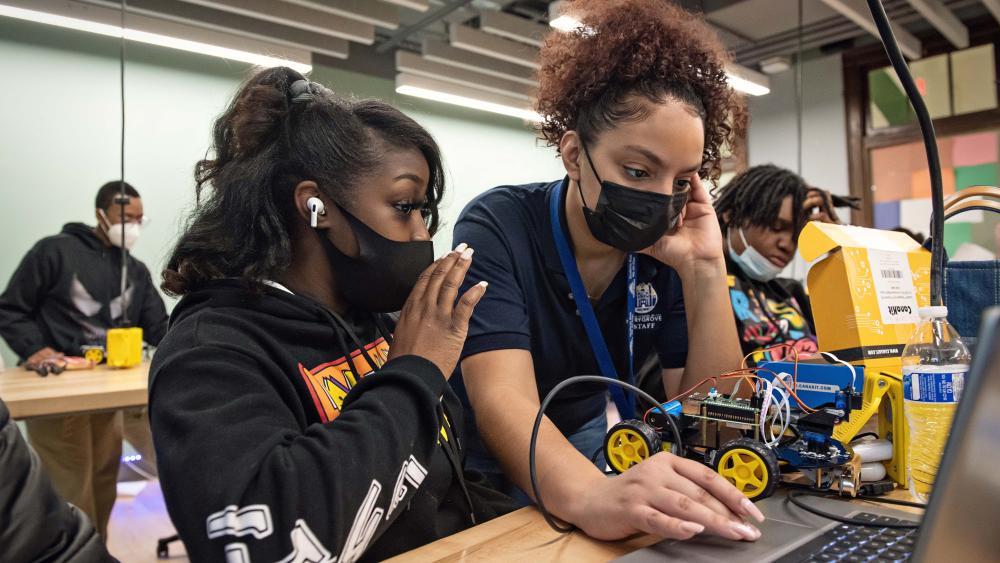 Teacher at Marygrove highschool helping highschool student