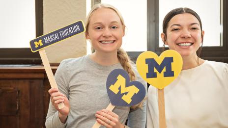 Two students smiling at the Marsal Family School of Education event